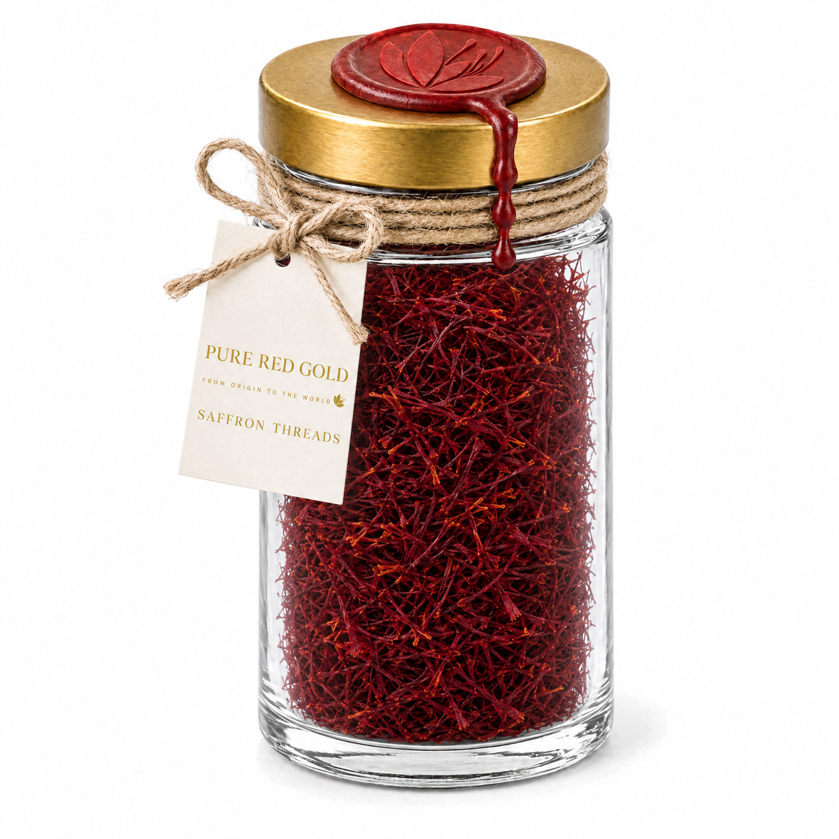 Tall 15 g clear glass jar of Super Negin saffron threads with a brushed gold screw lid, crimson wax medallion embossed with the crocus, jute twine and a cream hang tag reading PURE RED GOLD - FROM ORIGIN TO THE WORLD - SAFFRON THREADS, on white