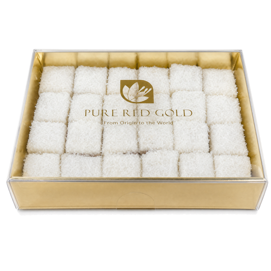 Gold gift box with a clear lid holding coconut-coated Signature Coconut delights, the PURE RED GOLD lockup printed in gold on the lid, on white