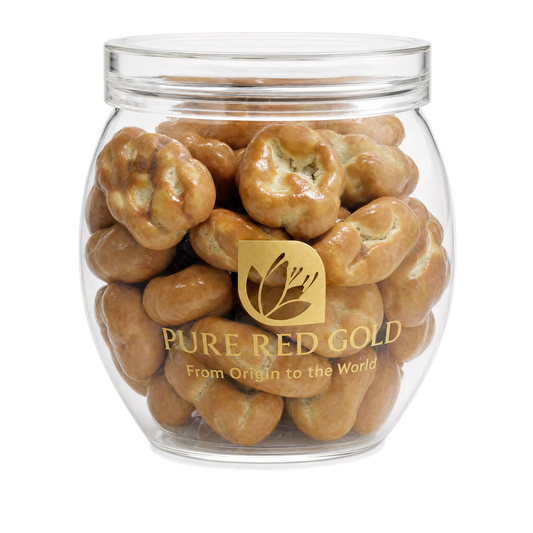 Pecan caramel confection in a Pure Red Gold gift box on white